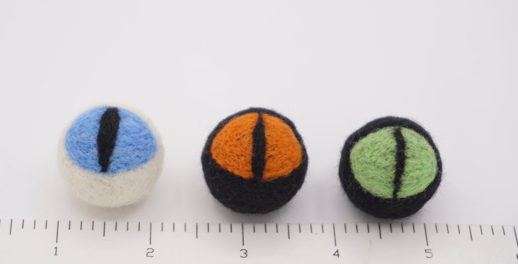 Each cat eye next to ruler. 