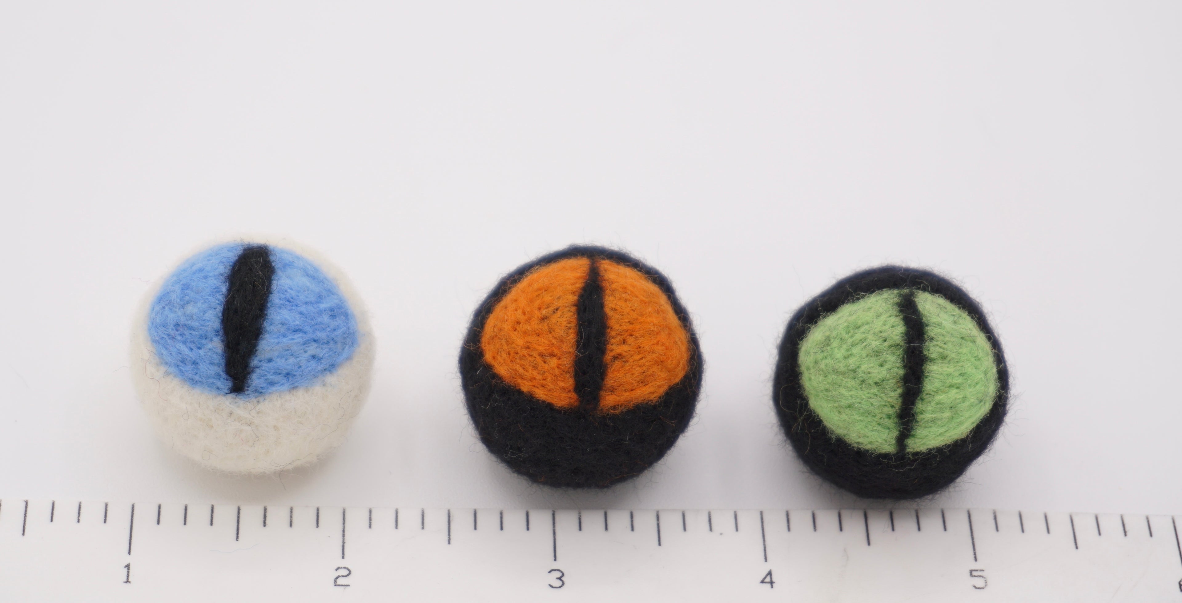 Each cat eye next to ruler. 