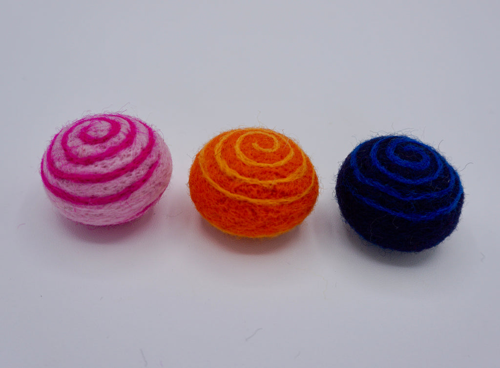 Swirly cat toys in a set of three in pink/neon pink swirl, orange/light orange  swirl & deep blue with neon blue swirl. 