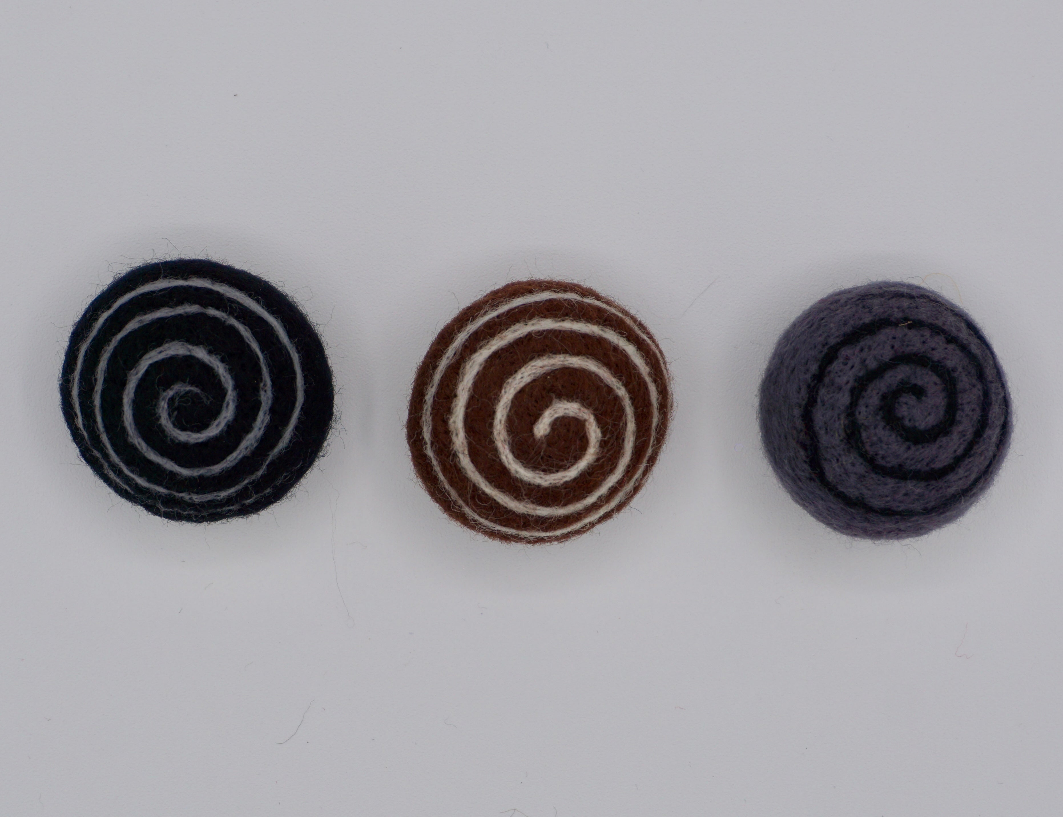 Comes in a set of three Swirly felts; black, brown & gray. 